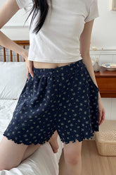 Model wearing Avauma Petitbloom mom shorts deepblue flower pattern while standing indoors.
